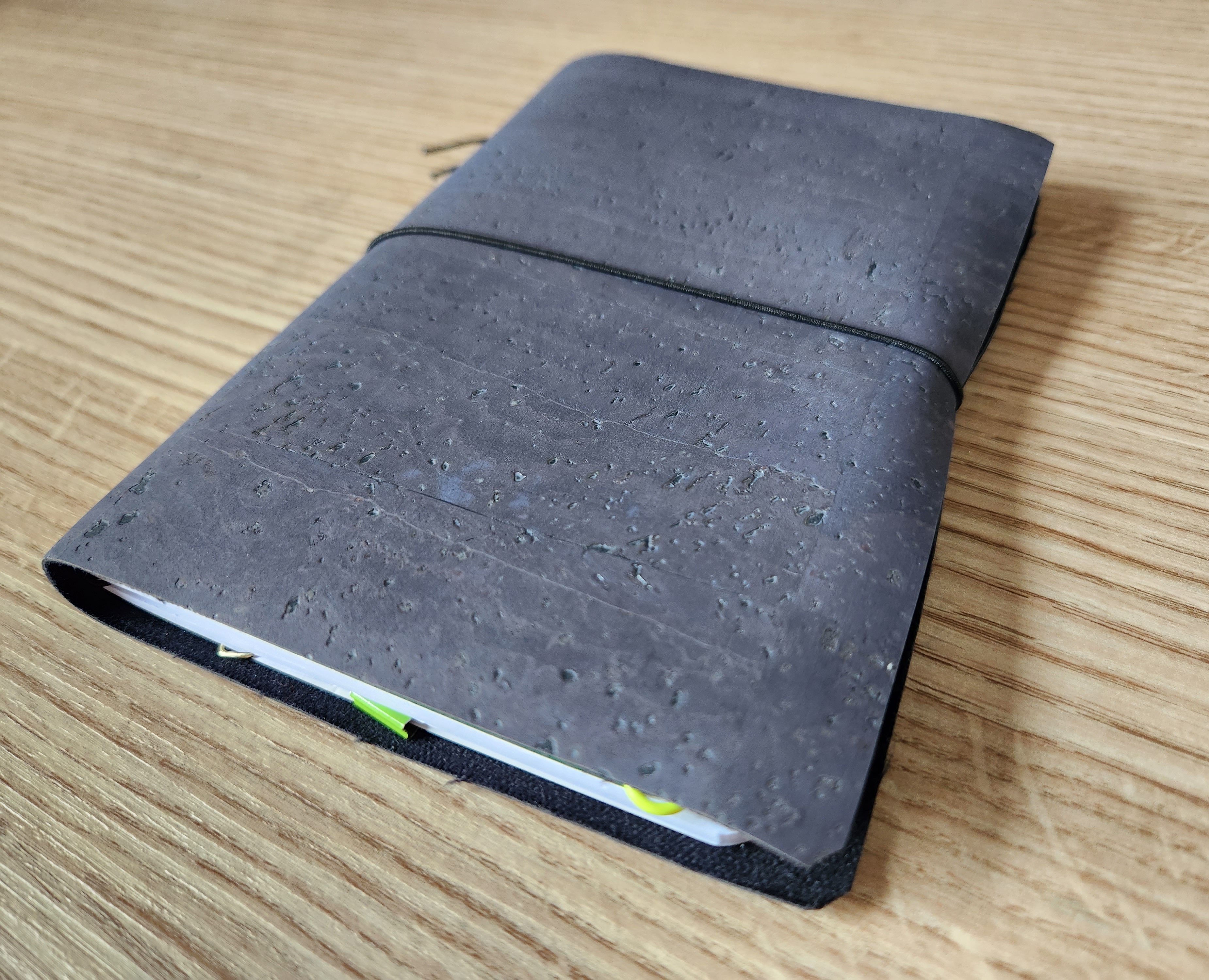 A handmade grey traveler's notebook, closed