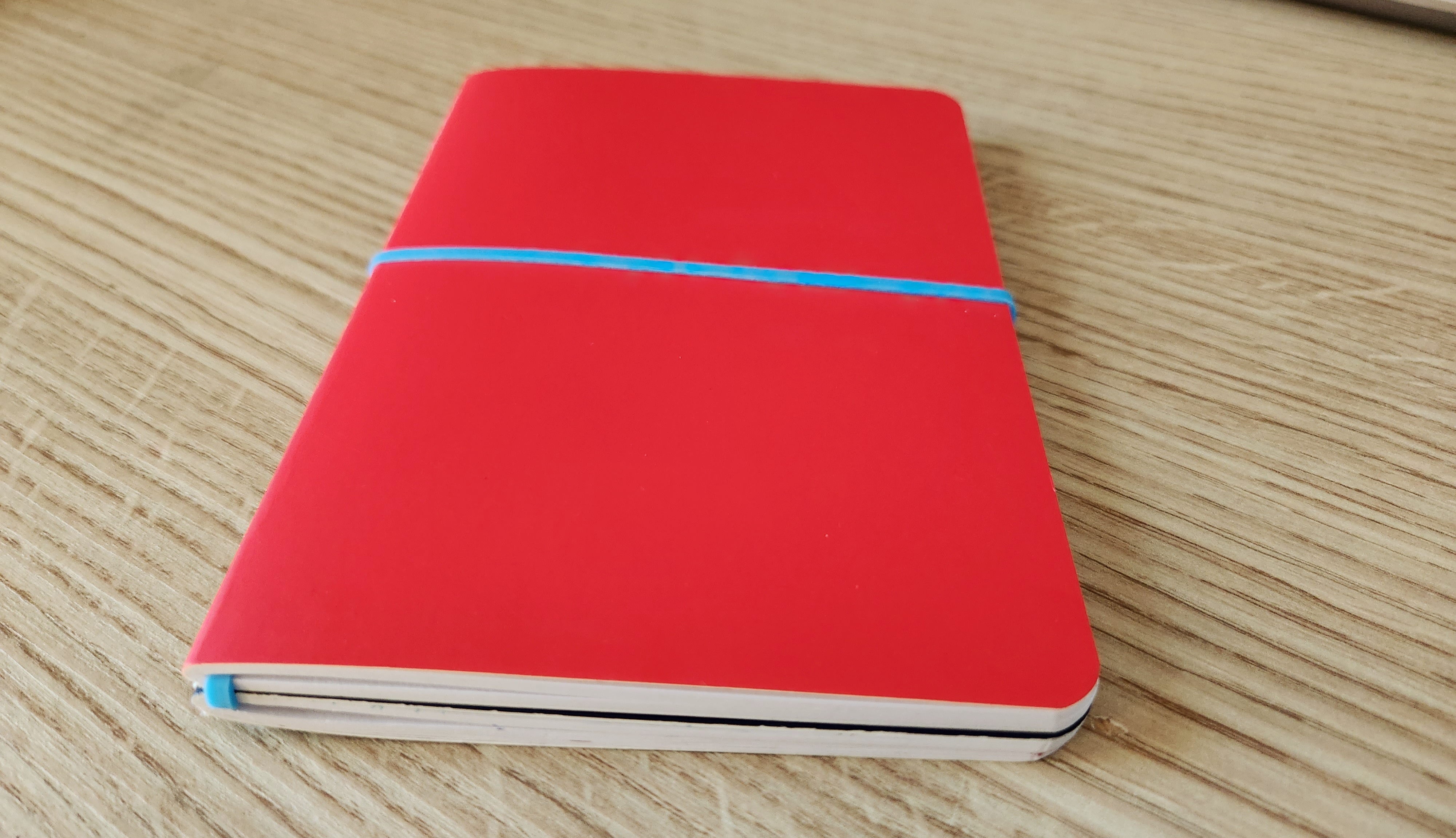 notebooks with rubber band wrapped around them